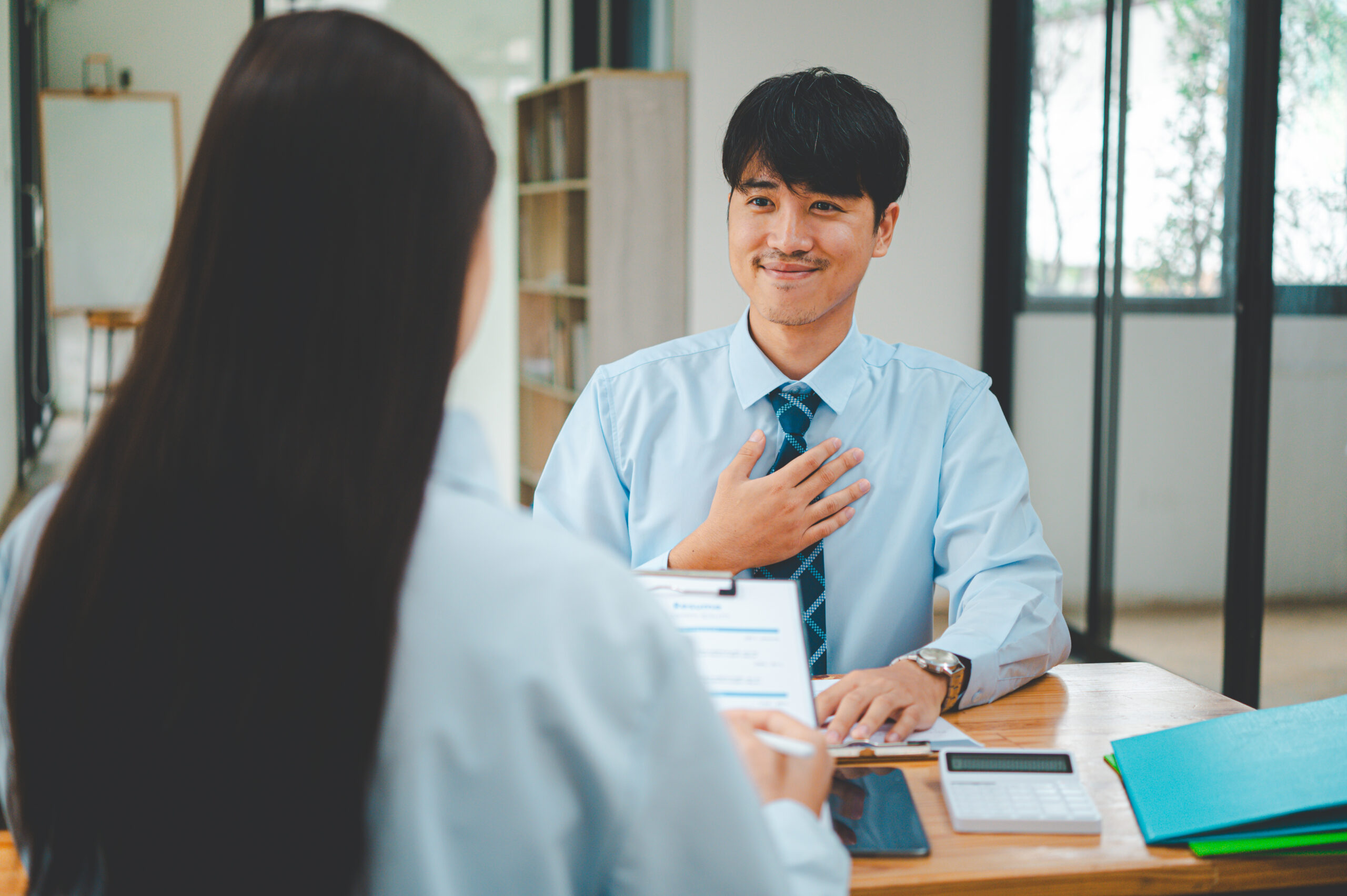 Man highlighting his achievement at a marketing job interview