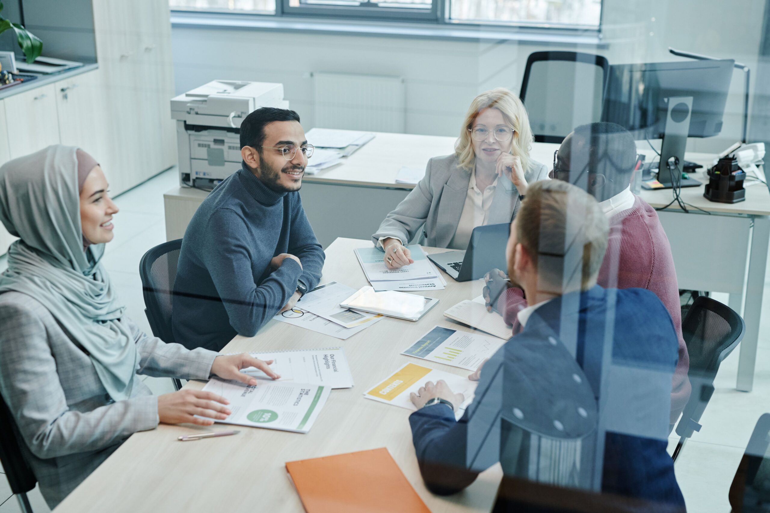 Professionals in entry-level sales careers collaborating during a sales strategy meeting focused on leadership and career growth.